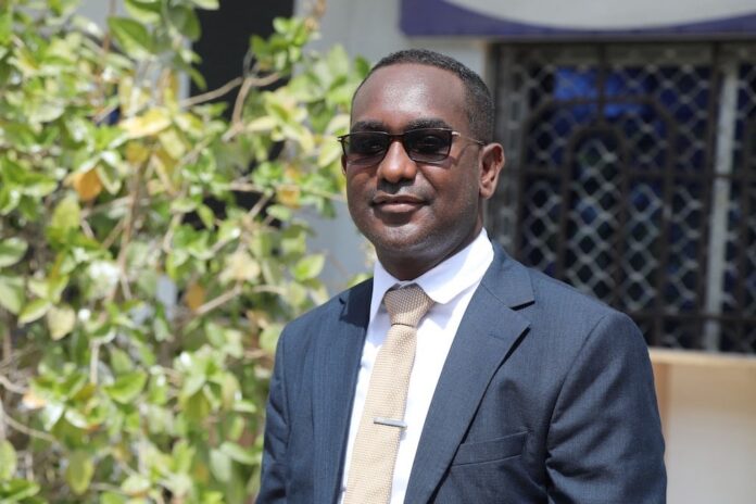 Somali journalist and secretary-general of the Somali Journalists Syndicate, Abdalle Ahmed poses for a photo outside the Banadir Regional Court on 4 January, 2023. | PHOTO/AFP.