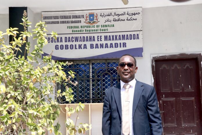 SJS Secretary-General, Abdalle Ahmed Mumin, stands outside the Banadir Regional Court on January 4, 2023. | PHOTO/SJS.