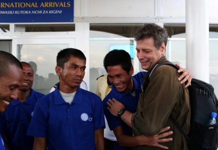 Michael Scott Moore (right), is seen welcoming other former hostages in Nairobi, Kenya, on October 23, 2016. A U.S. court recently convicted two men involved in Moore's 2012 kidnapping. | PHOTO/Reuters.