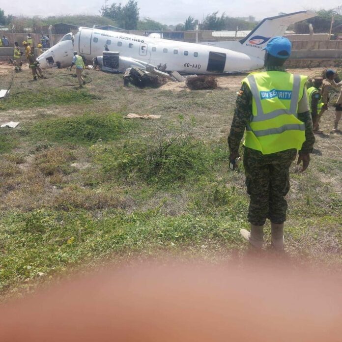 A security officer is seen near the site of the plane crash on Tuesday at Aden Adde International Airport in Mogadishu.