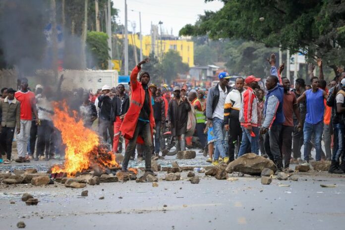 Protesters stand by a burning barricade on a street in the Mathare neighborhood of Nairobi, Kenya, on July 12, 2023 [AP Photo]