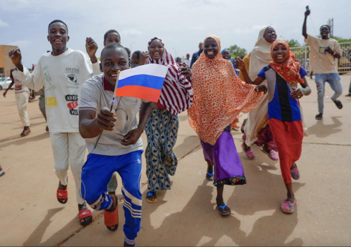 Nigerians wave Russian flag on the streets on Niamey as the deadline for the junta to hand over power back to the President Bazoum ends on Sunday. | Photo/ AP.