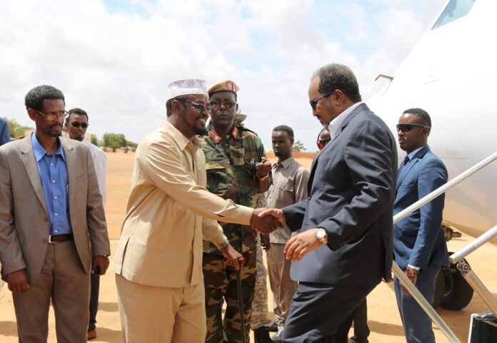 In this photo, President Hassan Sheikh Mohamud is seen being welcomed by President Ahmed Madobe during a visit to Kismayo in December 2016. | PHOTO/ OFFICIAL.