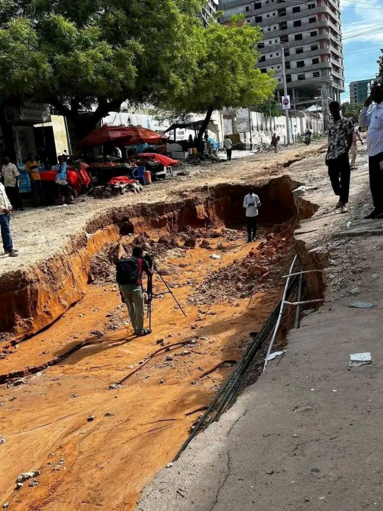A road in central Mogadishu turned into a deep crater as flooding eroded the surface. A road in central Mogadishu turned into a deep crater as flooding eroded the surface.