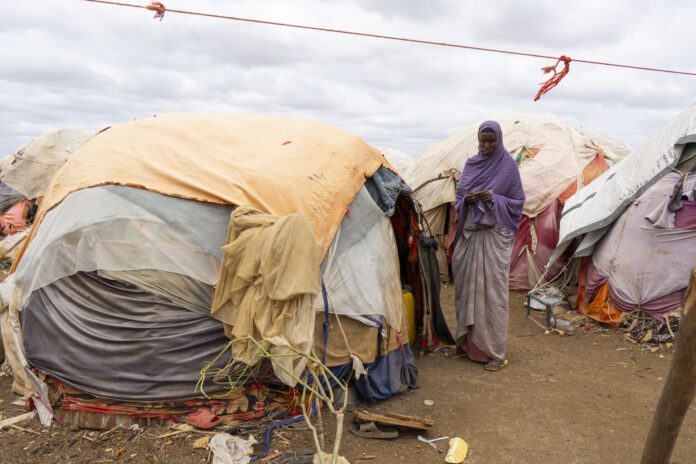 Safia Ahmed, a displaced mother of 3 children outside of her temporary shelter in Baidoa. | PHOTO/NRC.