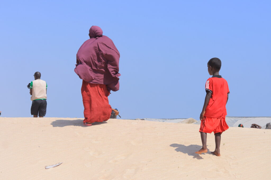 A woman and her son walk through sand in Kulub village, eastern Mudug region, central Somalia in September, 2025. PHOTO: Said Abdullahi.