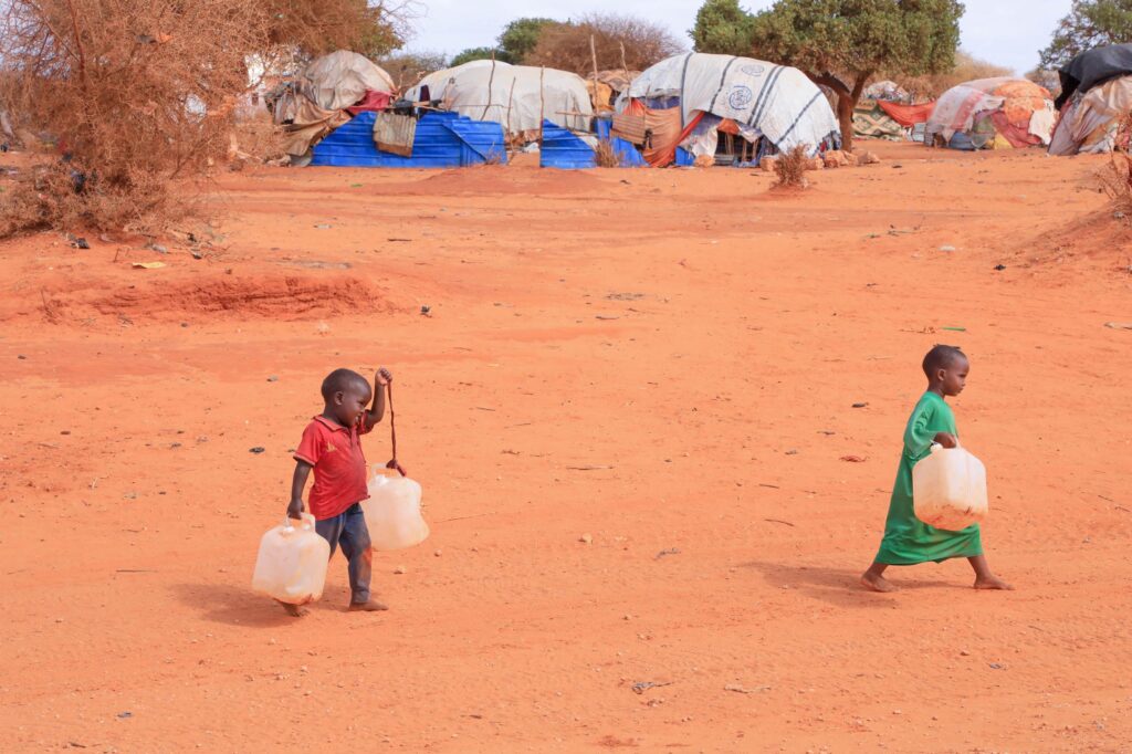 Children carry jerrycans in Barkadda Shariifadda village, about 13 km west of Kismayo, Jubaland, while waiting for a water trucking vehicle brought by an NGO from Kismayo. This is the only water the community can access to survive. PHOTO/ABDULLAAHI HUSSEIN KILAS/ KAAB TV.