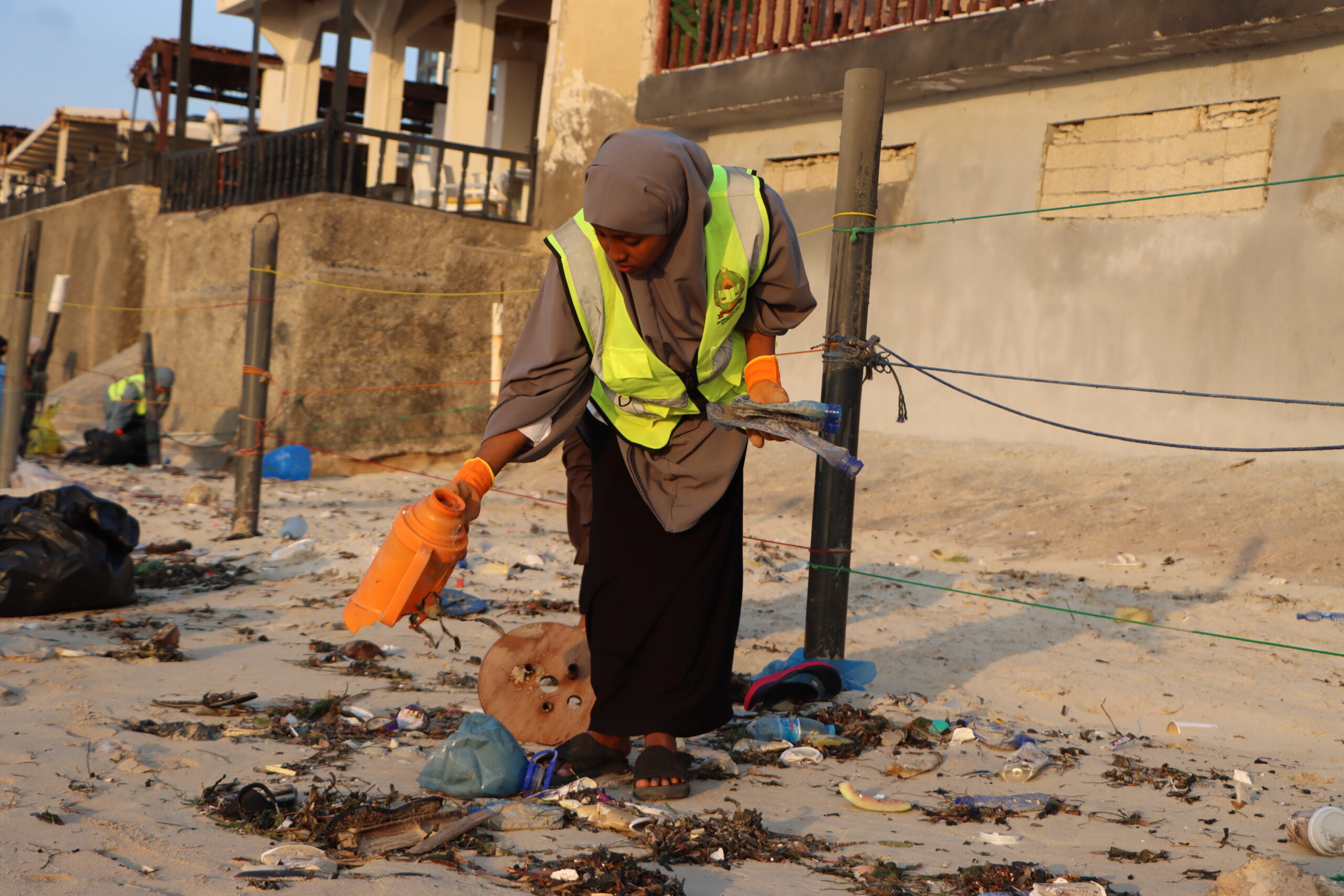 Young university students spend their weekends clearing waste from Mogadishu's Lido Beach, as Somalia battles the compounding toll of climate change, toxic dumping, and coastal degradation. | PHOTO/Said Yusuf Warsame.