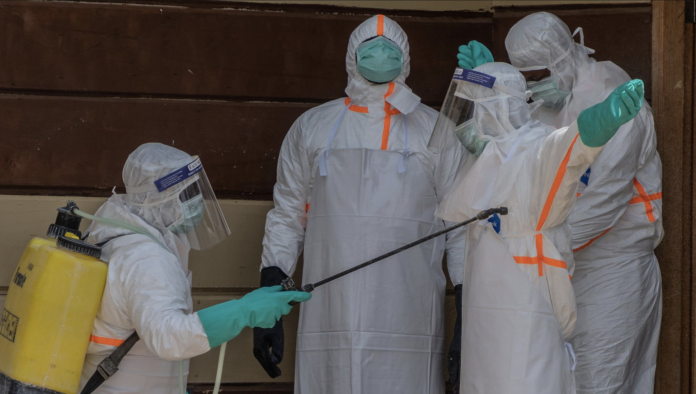 Health workers disinfect themselves. PHOTO/ AP