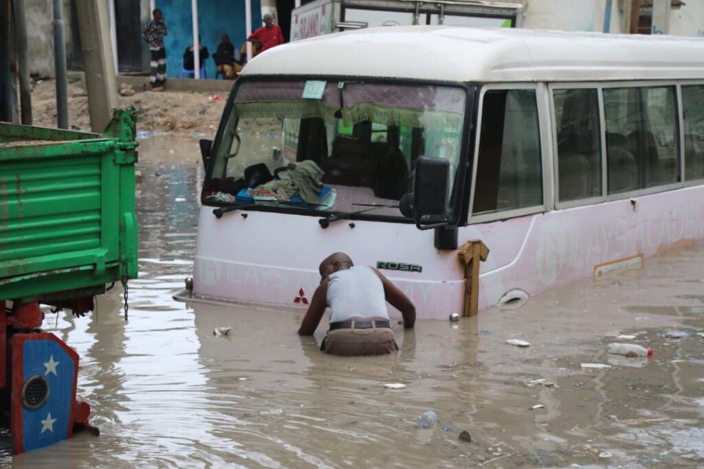 Mogadishu residents struggle through flooded streets. Photo taken Sunday 21 June, 2026. | Kaab TV.